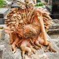 A wood-carved pelican tombstone